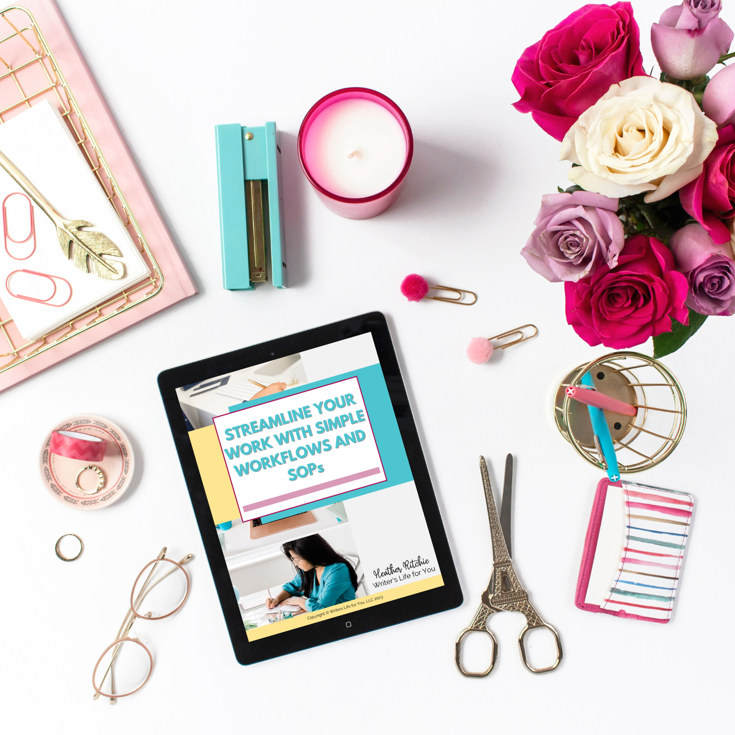 A workspace featuring an iPad displaying a document titled "Streamline Your Work With Workflows and SOPs" by ContentPreneur Biz Shop, surrounded by office supplies including glasses, scissors, a candle, flowers, binder clips, a pencil case, and a stapler to enhance business efficiency.