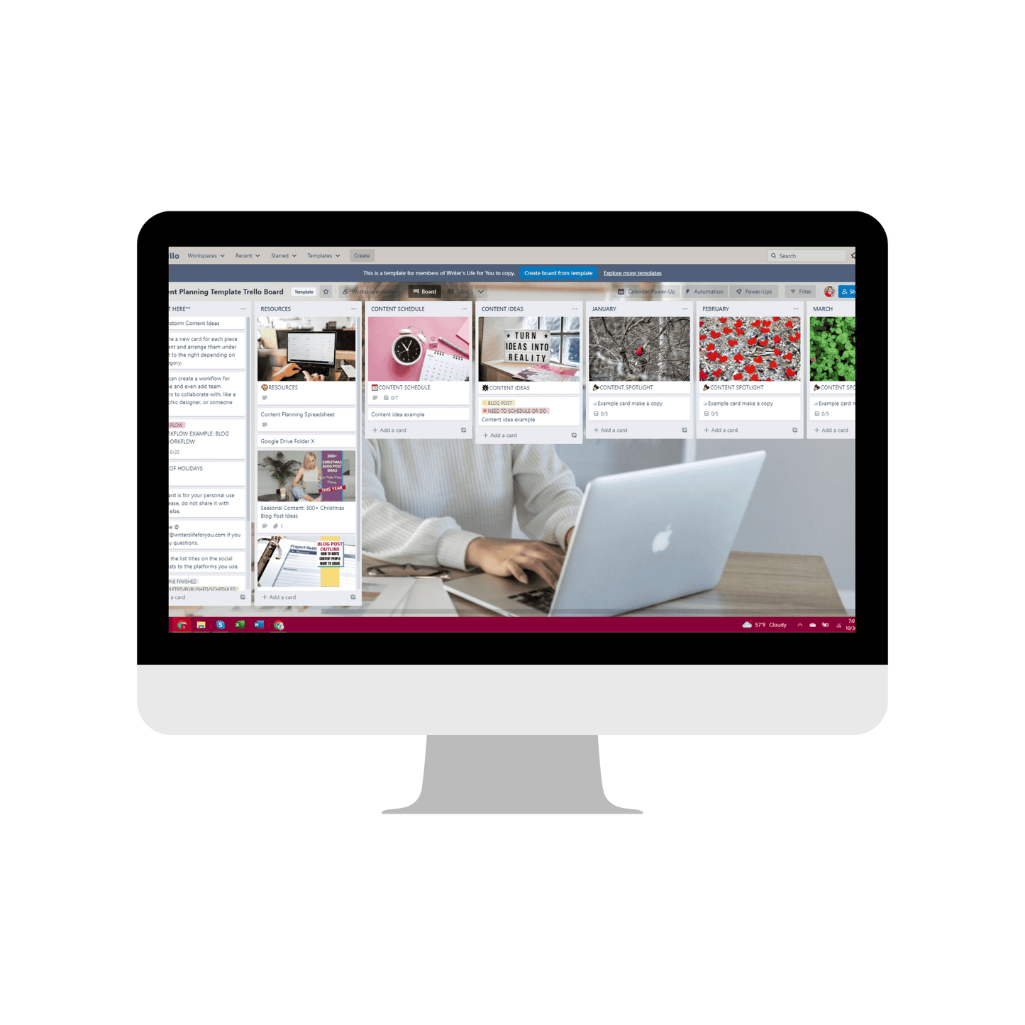 A Content Catalyst SEO Hub monitor from ContentPreneur Biz Shop displays a Trello board interface for yearly content planning. The screen shows various cards organized in columns, representing tasks or projects. A person types on a laptop in front of the monitor, optimizing content creation based on AI-powered data.